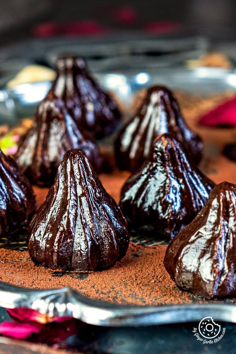 close up shot of chocolate modak on a steel plate