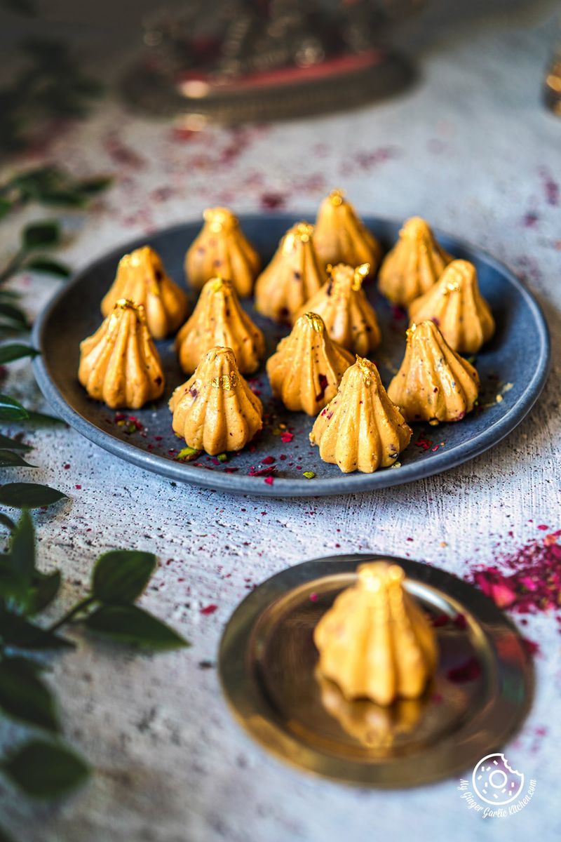 photo of a plate of Dulce De Leche Modaks on a table with a plate of modaks