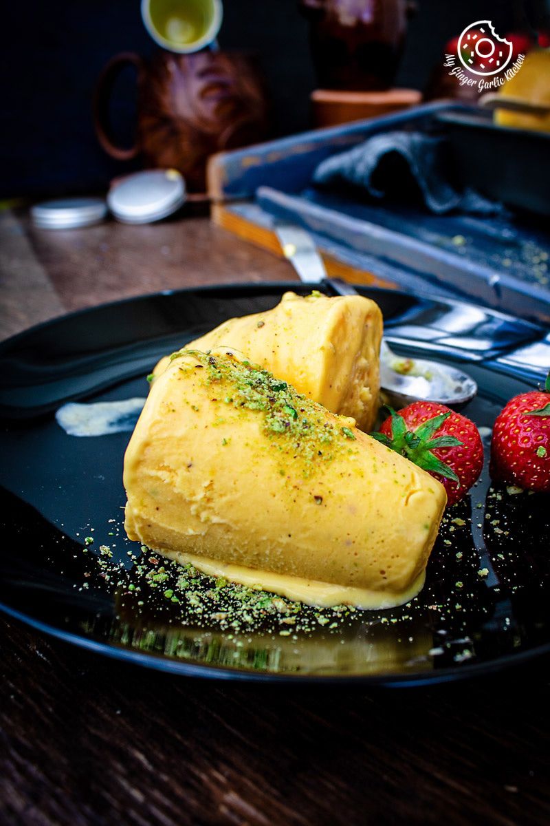 a plate with two mango kulfis on it