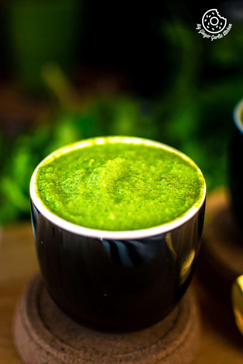 mint coriander chutney served in a black bowl