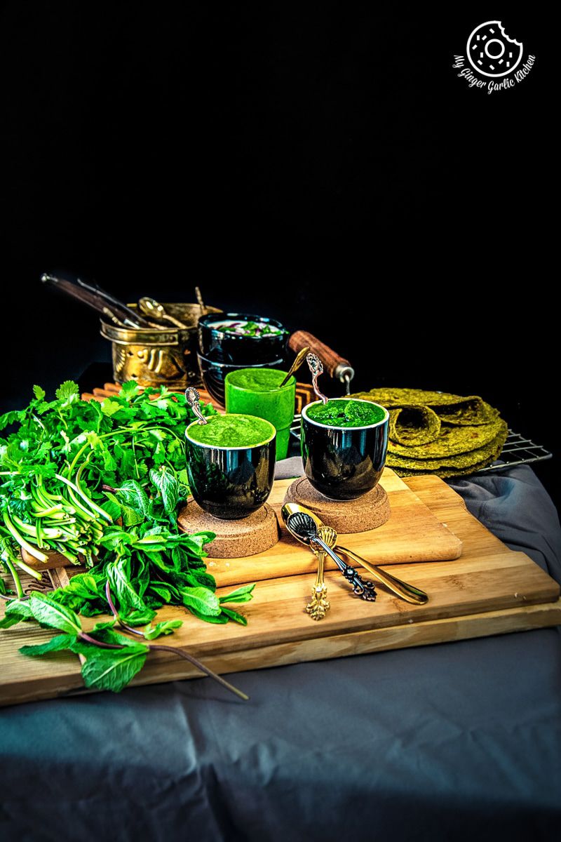 mint coriander chutneys served in black ceramic bowls