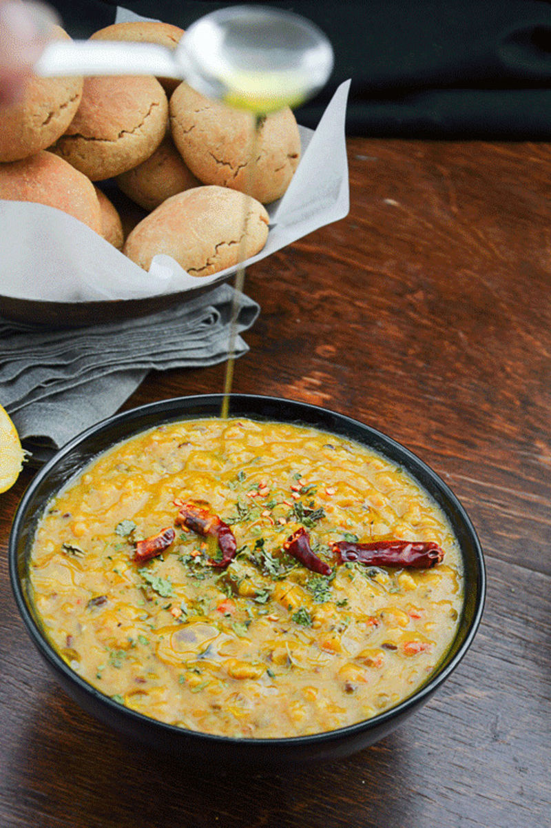 a bowl of dal with a spoon in it