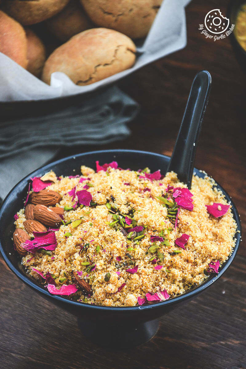 a bowl of churma with a spoon in it