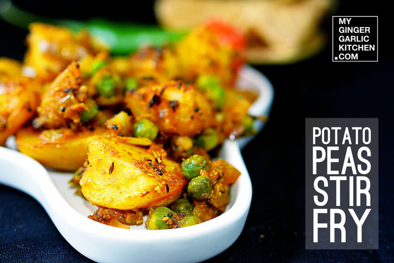 there is a white bowl filled with potato peas stir fry